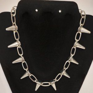 Silver Spike Necklace. 8 inches long. Has 10 spikes on silver chain.